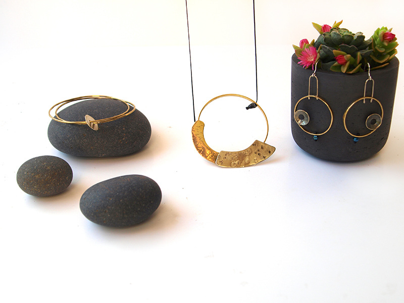 gold jewellery on black rocks and other items